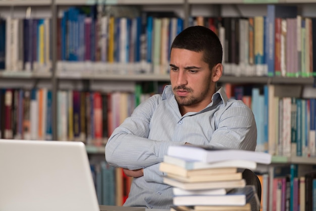 Stressed Student Of High School Sitting At The Library Desk  Shallow Depth Of Field