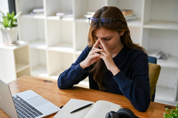 A stressed thoughtful Asian businesswoman worried about the project's deadline