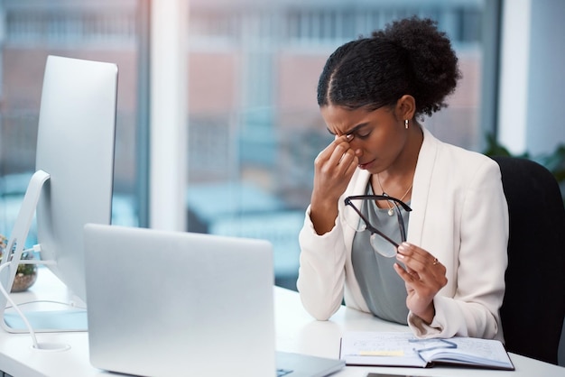 Stressed tired and frustrated businesswoman with headache eye strain and burnout making mistake on office laptop Overworked creative entrepreneur failing to meet deadline or plan startup strategy