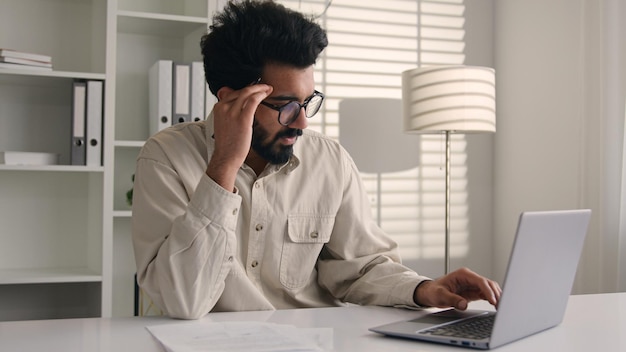 Stressed tired male muslim businessman arabian indian man sad frustrated entrepreneur manager office