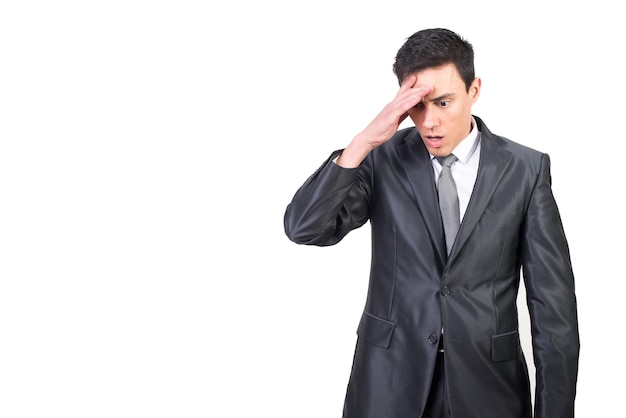 Stressful man in formal suit touching forehead