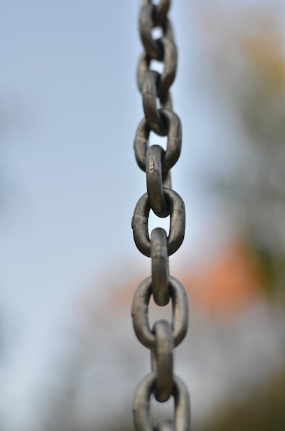 Stretched metal chain on a blurred surface