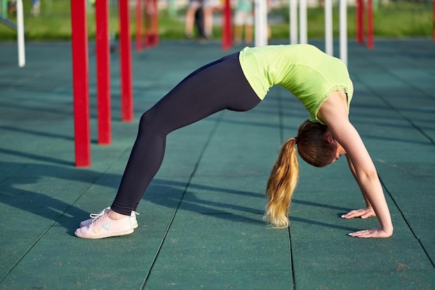 Stretching danser or gymnast woman training trains in workout sports ground Doing exercise bridge