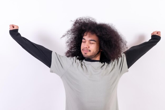 Stretching and waking up Young boy with afro hair on white background