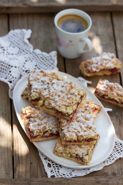 Streusel pie stuffed with rose jam, served with coffee. Rustic style.