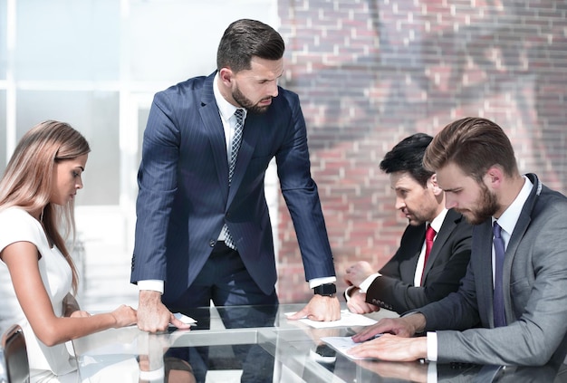 Strict businessman talking to employees