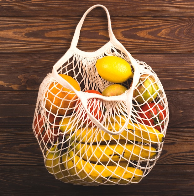 Photo a string bag full of fruits and vegetables. eco life style.