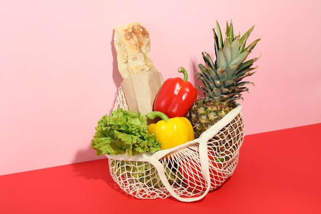 String bag with grocery on two tone background