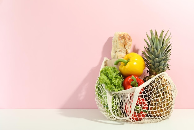 String bag with grocery on two tone background