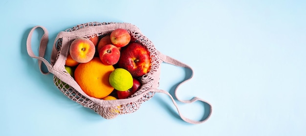 String mesh bag for grocery with various fruits Reusable shopping tote bag zero waste concept