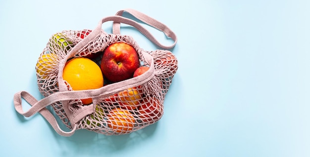 String mesh bag for grocery with various fruits Reusable shopping tote bag zero waste concept