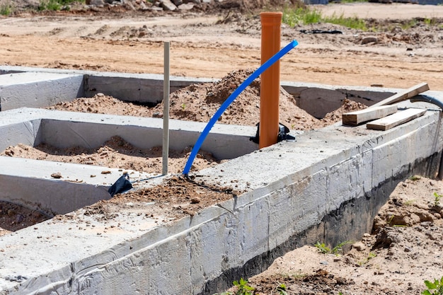 Strip foundation of a new building The foundation for the construction of the walls of the house Conducting communications to the building under the foundation