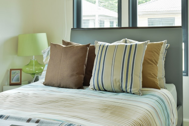 Striped bedding in modern decorated bedroom