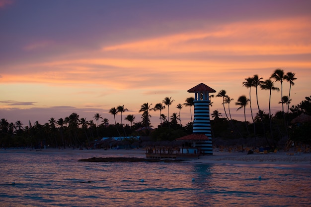 Striped red white lighthouse on the coast of the Caribbean Sea. Dominican Republic.