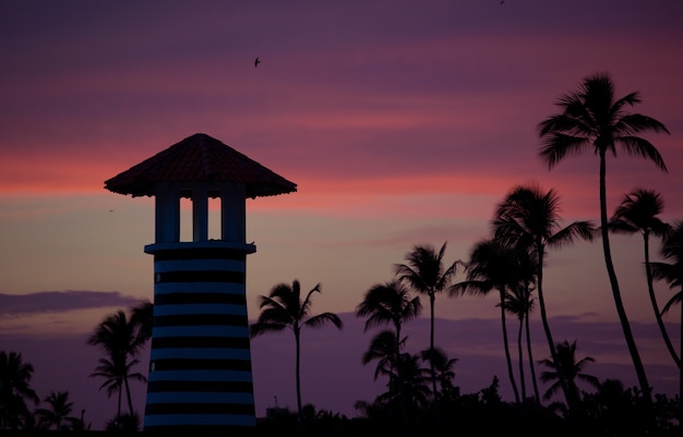 Striped red white lighthouse on the coast of the Caribbean Sea. Dominican Republic.