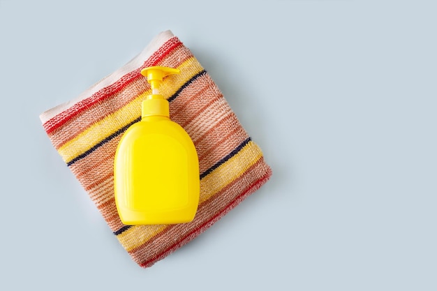 Striped terry towel and liquid soap bottle copy space mockup