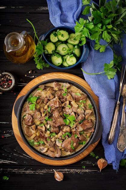 Stroganoff chicken liver with mushrooms and cream. Flat lay. Top view