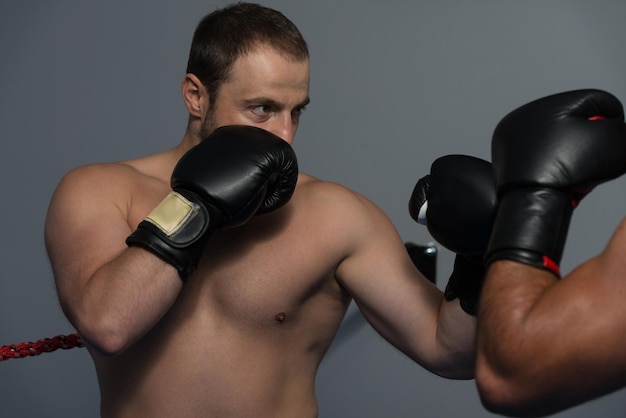 Strong Boxer And His Opponent During A Box Fight In A Ring