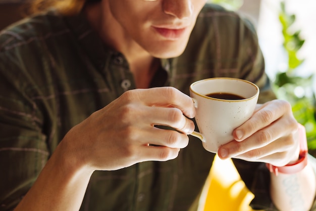 Strong coffee. Close up of a cup with strong coffee while being in male hands