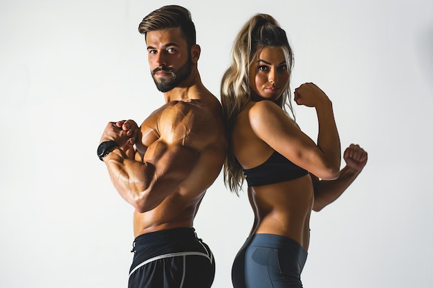 Strong Fit Couple BacktoBack in Gym Displaying Muscular Builds and Determination During Intense Wo