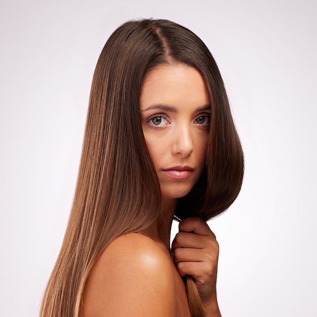 Strong healthy hair Studio portrait of an attractive young woman posing against a grey background