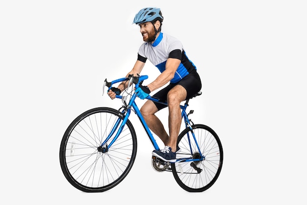 Strong male cyclist making effort to ride fast on bike