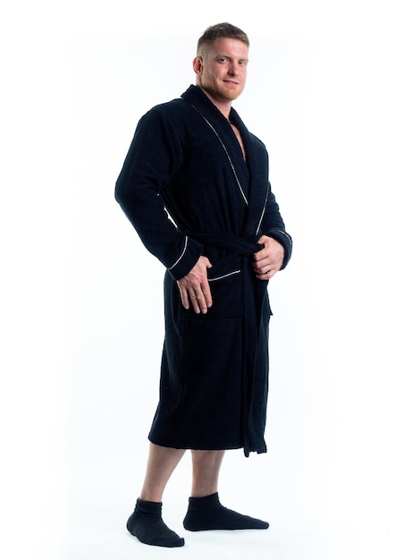 Strong man in a Bathrobe on an isolated white background with a smile on his face