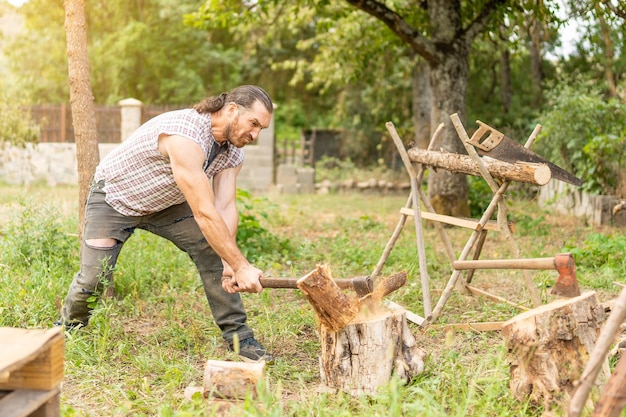 Strong man chopping a log on a garden