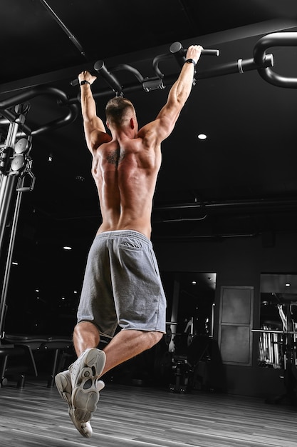 Strong man doing exercises at the gym