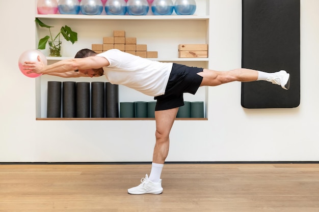 Strong man exercising with fluiball in gym