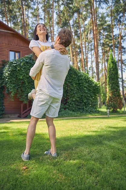 strong man having fun with lovely girlfriend in the outdoors