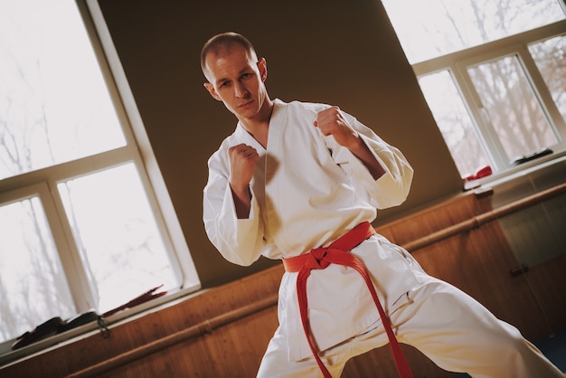 Strong man martial arts fighter in white training moves.