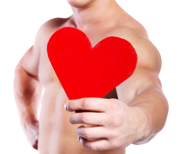 Strong muscular man holding red valentine's heart at white background