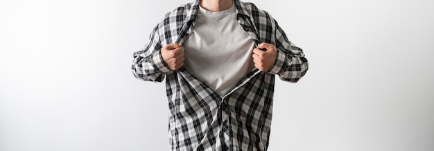 A strong person breaks his shirt and opens shirt as a super hero template mockup