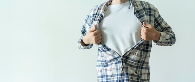 A strong person breaks his shirt and opens shirt as a super hero template mockup