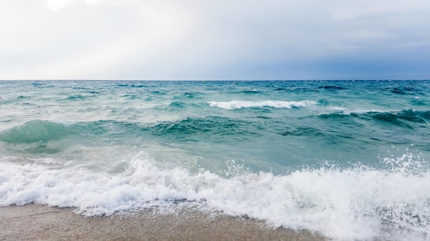 Strong waves crash over the beach Beautiful seascape.