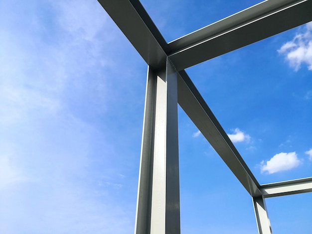 Structure of steel building construction with blue sky background.