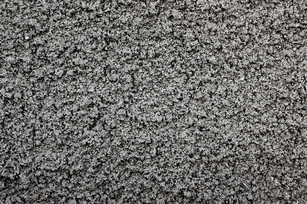 Structure of the wall with coarse gray cement plaster