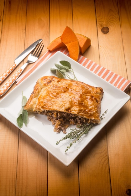 Strudel stuffed with chopped meat pumpkin and herbs