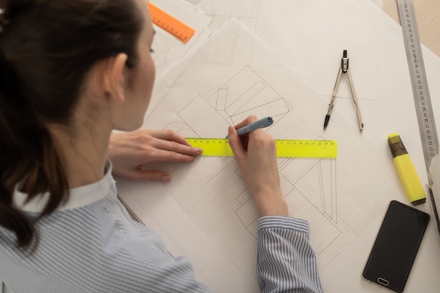 Student architect draws geometric shapes, design practice