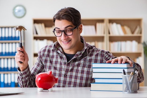 Student breaking piggybank to pay for tuition fees