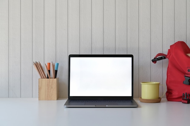 Student desk with blank screen laptop,