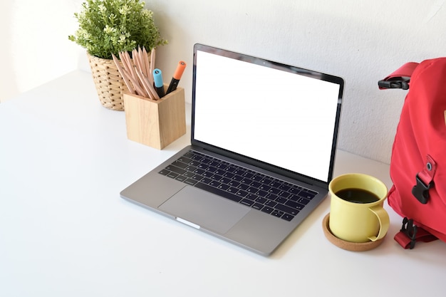 Student desk with blank screen laptop,