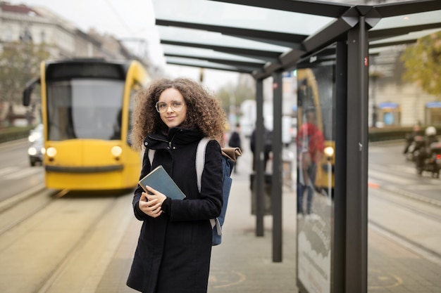 Student girl waiting the tram