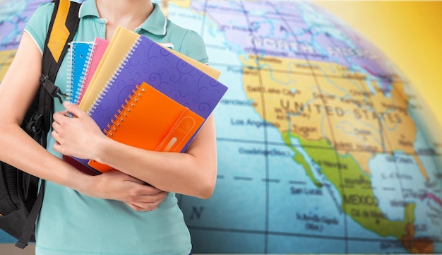 student hand with books and map, learn languages