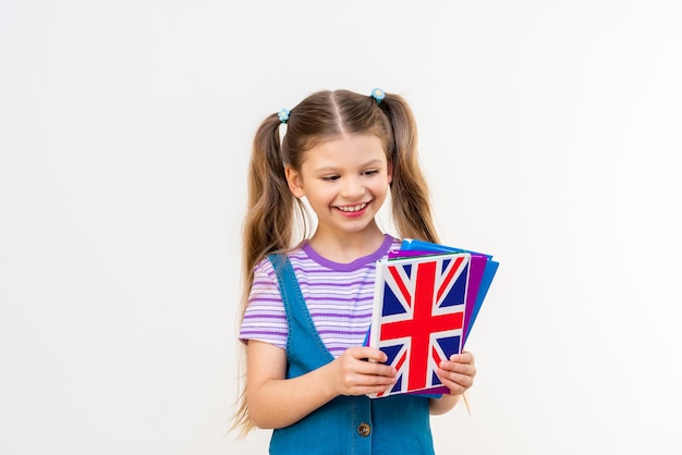 The student is learning English. A schoolgirl with an English book.