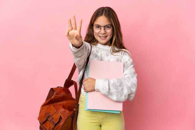 Student little girl over isolated pink wall happy and counting three with fingers