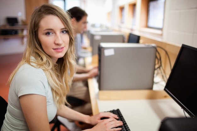 Student posing with a computer