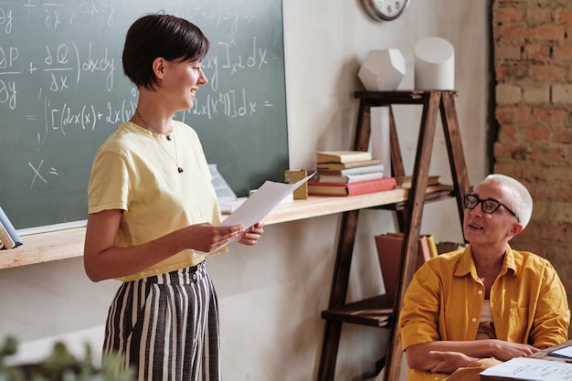 Student presenting report to teacher