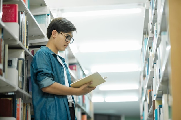 Student reading book at library